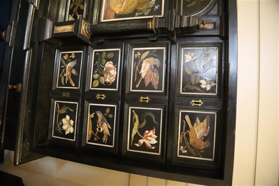 A 17th/18th century Italian and later pietra dura and ebony veneered cabinet on an ebonised wood stand, W.4ft 2in. D.1ft 7in. H.4ft 6.5